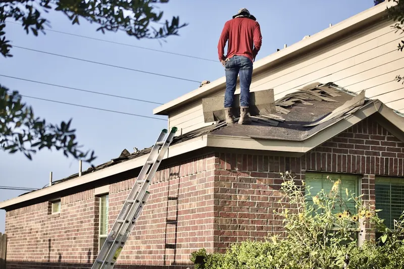 Professional roofer working on a residential roof in Ledbetter Gardens